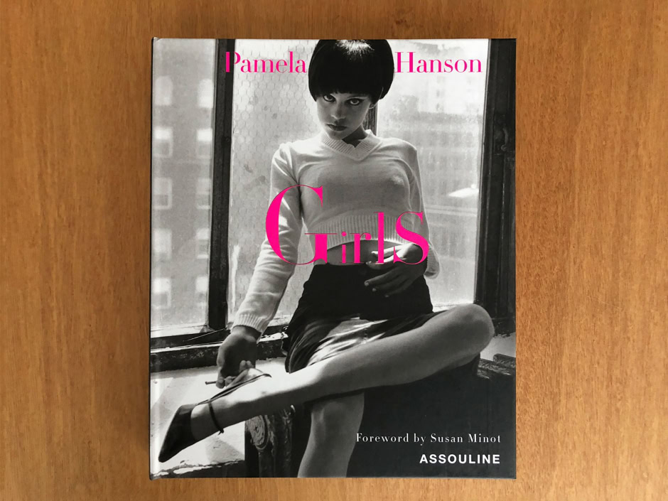 Vintage black and white photograph of a girl sitting by a window, with text overlay for Pamela Hanson Girls photo book, showcasing her photographic style focused on fashion and women's portraiture.