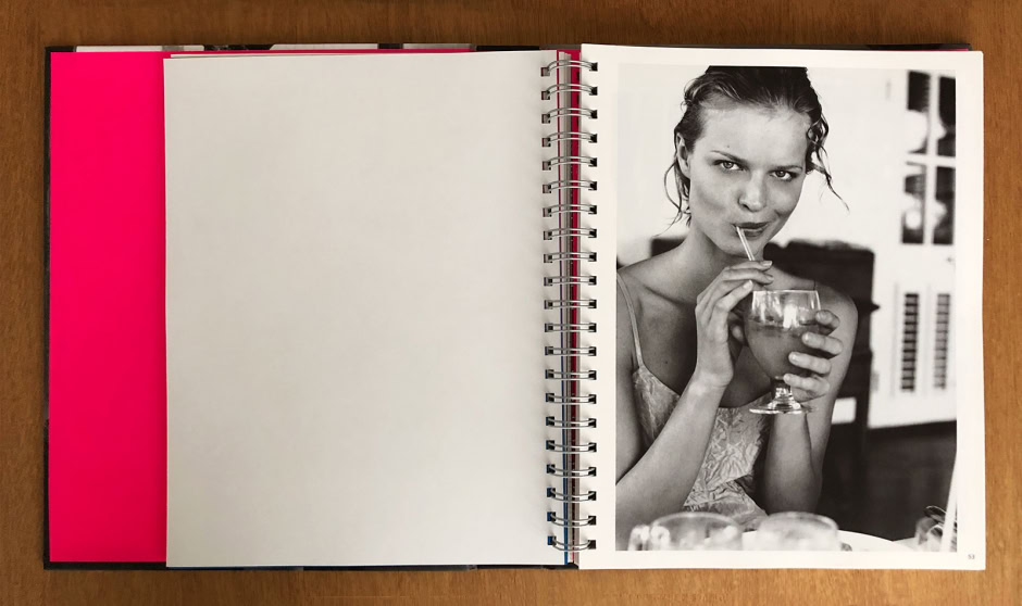 Elegant black and white portrait of a young woman sipping a cocktail, showcasing Pamela Hanson's high-end fashion photography style and capturing natural beauty and candid moments.