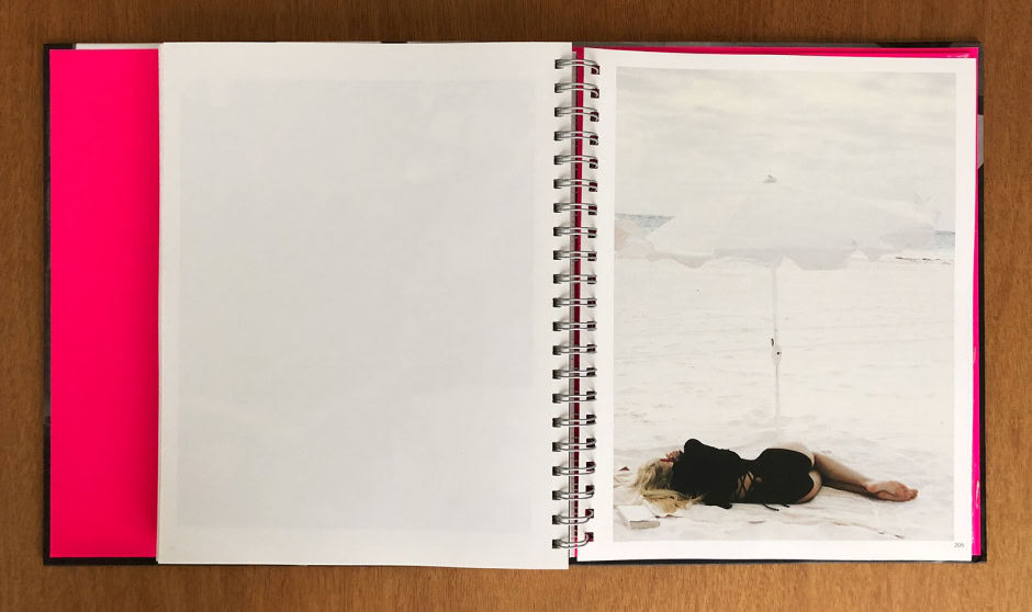 Beautiful woman relaxing on a beach during a styled photoshoot, captured in a minimalist, artistic fashion by renowned photographer Pamela Hanson.