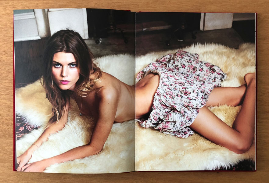 Elegant female model lying on a fluffy fur rug, capturing sensual portrait photography by Pamela Hanson, emphasizing fine art and fashion photography, studio setting, professional model, soft lighting.