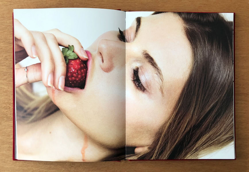 Strawberry being eaten by a woman, showcasing sensual portrait photography, beauty, and fine art photography by Pamela Hanson.