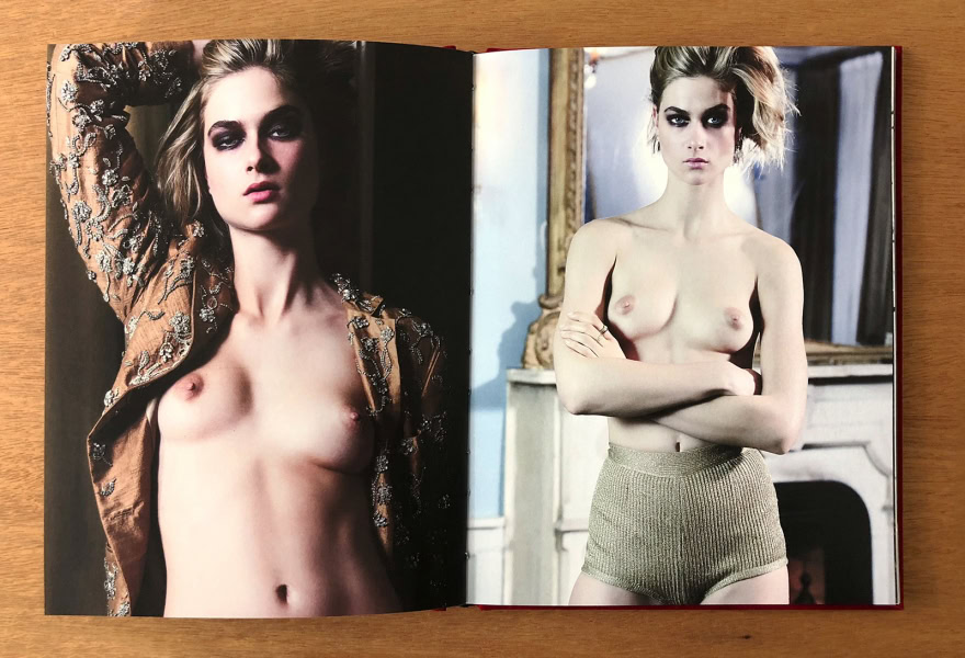 Elegant portrait of a topless model with styled hair, wearing a detailed jacket, showcasing high fashion photography by Pamela Hanson.