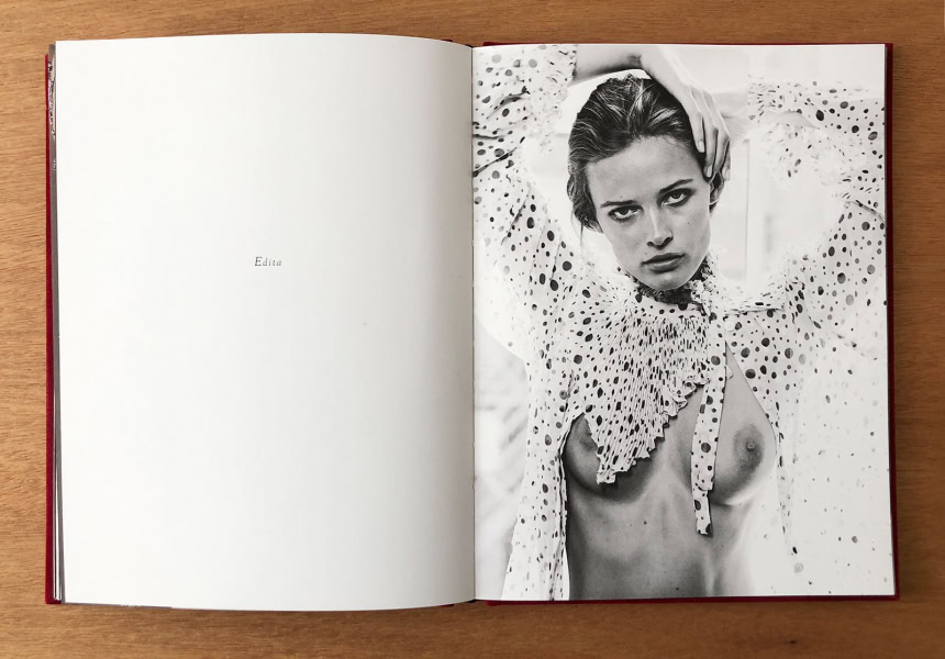 Elegant black and white portrait of a woman with intense gaze, wearing a polka dot blouse with ruffled collar, showcasing high fashion photography by Pamela Hanson.