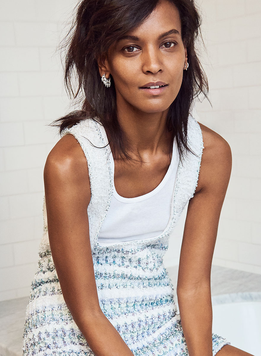 Elegant woman portrait showcasing contemporary fashion photography by Pamela Hanson, featuring stylish clothing, jewelry, and a confident pose.