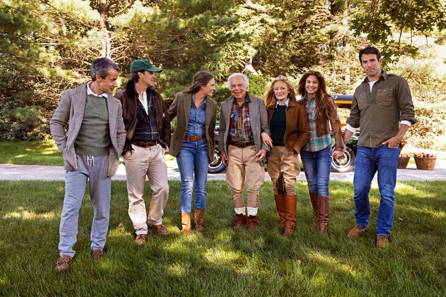 Family outdoor gathering, diverse age group enjoying nature in a lush green park, candid moment, casual clothing, bright daylight, happy family bond, professional lifestyle photography by Pamela Hanson.