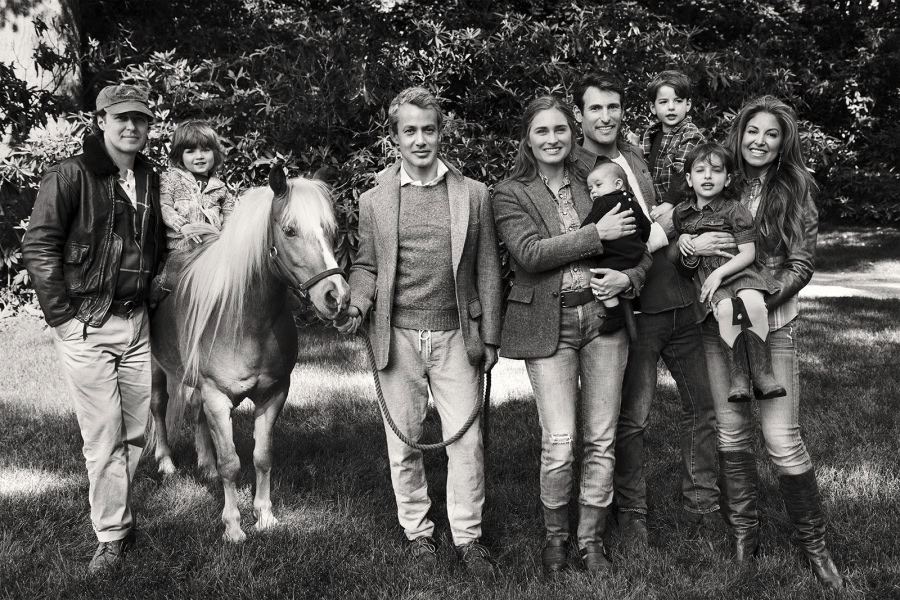 Family portrait of multiple generations outdoors with children, parents, and a pony, showcasing professional photography by Pamela Hanson for family and portrait photography.