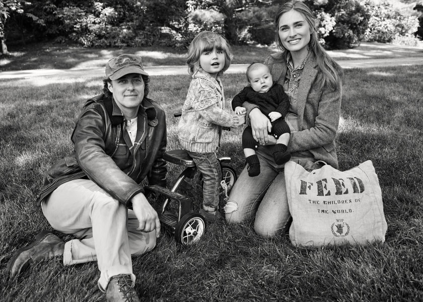 Family outdoor portrait in black and white featuring parents and children during a community service event, highlighting emotional connection, natural setting, and candid moment, captured by Pamela Hanson Photography.