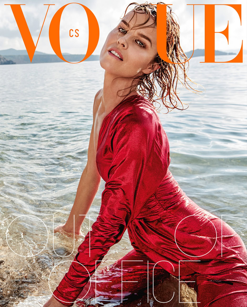 Vogue magazine cover featuring a female model in a red satin dress posing by the water at sunrise, highlighting fashion photography, high-end editorial style, and beauty photography.