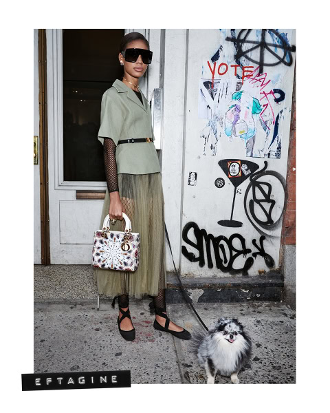 Vogue fashion model in edgy street style outfit with dog, graffiti wall, fashion photography.