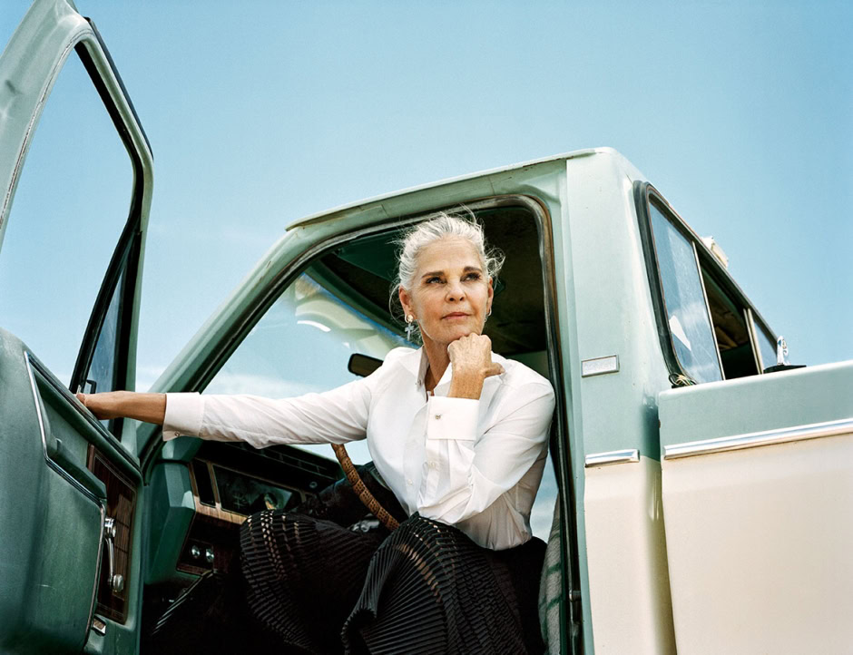 Elegant senior woman sitting in vintage truck, fashion portrait, stylish age photography, outdoor natural light, senior lifestyle shoot, timeless beauty, classic fashion photography.