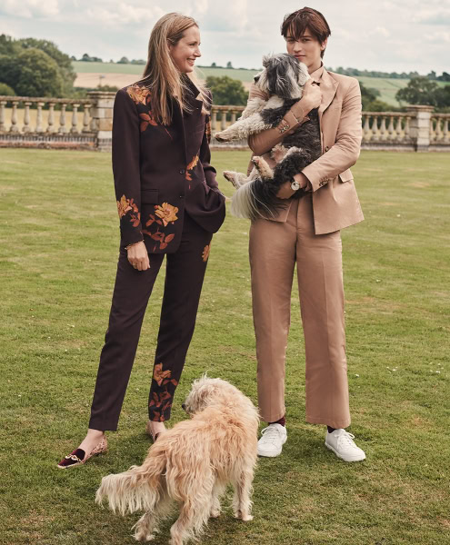 Women walking dog outdoor, stylish couple with small dogs on lawn, luxury fashion and leisure, Pamala Hanson photography, candid moment in nature.