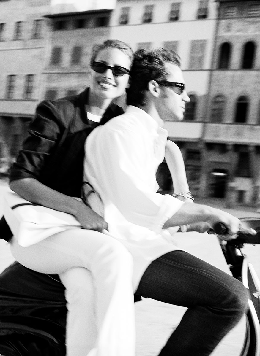 Stylish couple riding a bicycle in city, black and white photo, fashion photography by Pamela Hanson.