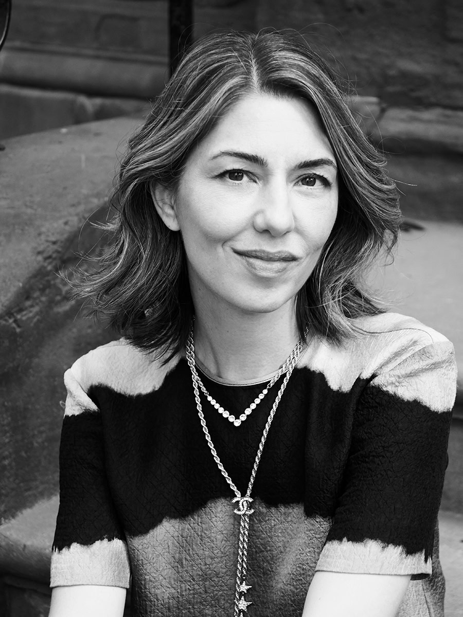 Elegant black and white portrait of a woman with graceful expression, stylish short hair, and layered jewelry, captured by Pamela Hanson Photography for sophisticated fashion and beauty photography.