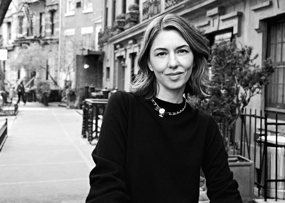 Elegant black and white portrait of a woman in an urban neighborhood, showcasing professional photography by Pamela Hanson.