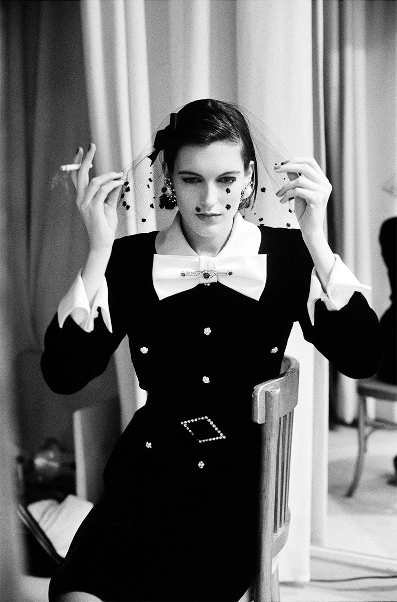 Elegant black and white portrait of a woman with vintage style fashion, sophisticated jewelry, and classic makeup in a photography by Pamela Hanson.