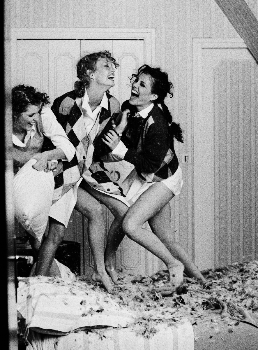 A1: black and white lifestyle photography of women laughing and having fun indoors, capturing genuine joy and friendship.
