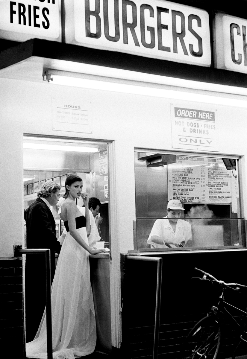 Burgers stand at night food truck with steam and customers, black and white photography, street scene.