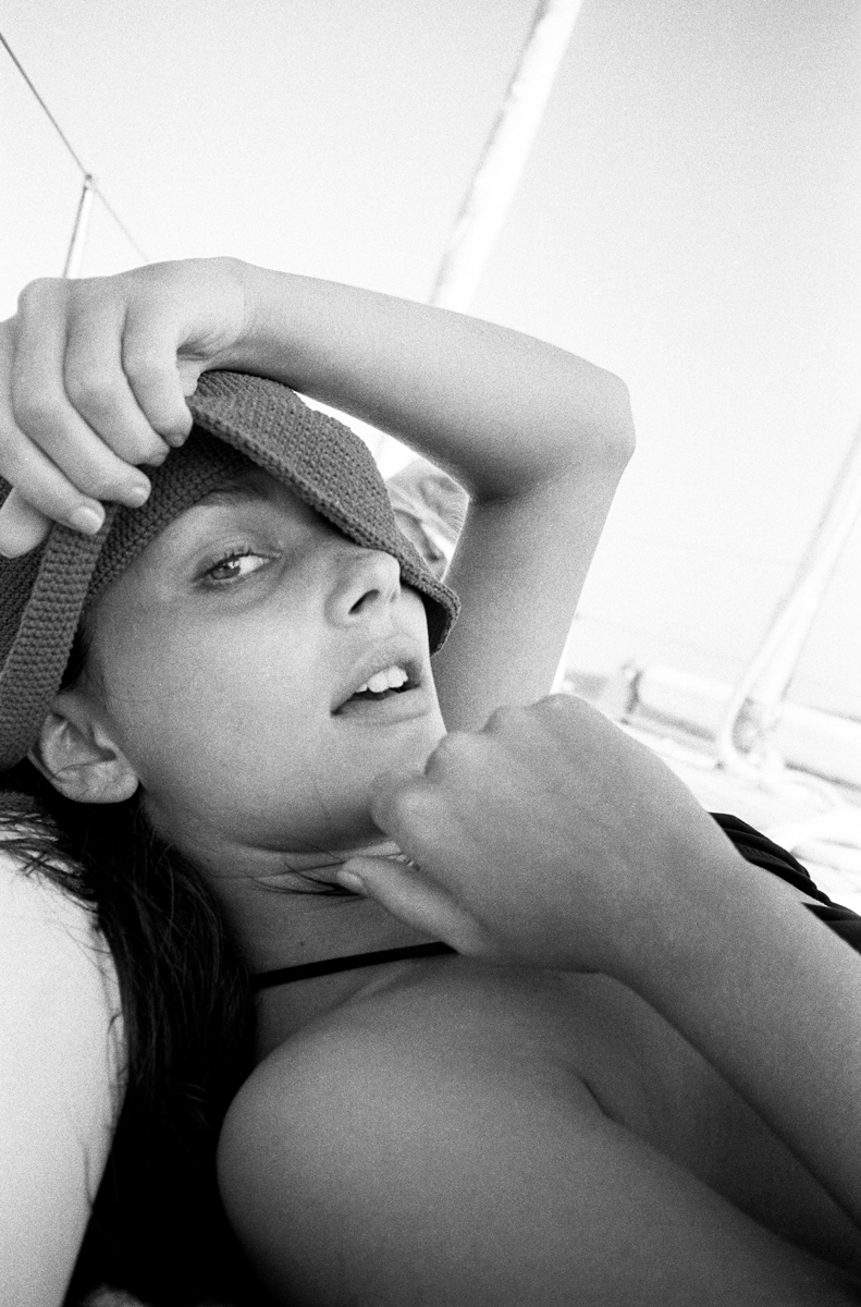 Young woman relaxing on beach, black and white photography, sensual portrait, intimate lifestyle shot, elegant and artistic beach session, Pamela Hanson Photography style, fashion and leisure photography, fine art portrait.