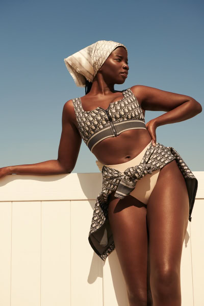 Dior patterned swimwear and cover-up styled photo shoot featuring a confident woman with dark skin, outdoors against a clear blue sky, showcasing fashion photography by Pamela Hanson.