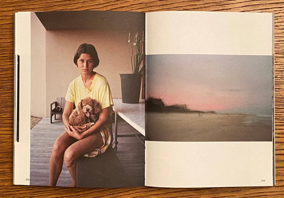 Elegant portrait of a woman with a small dog in a modern home setting, showcasing contemporary photography and lifestyle photography by Pamela Hanson.