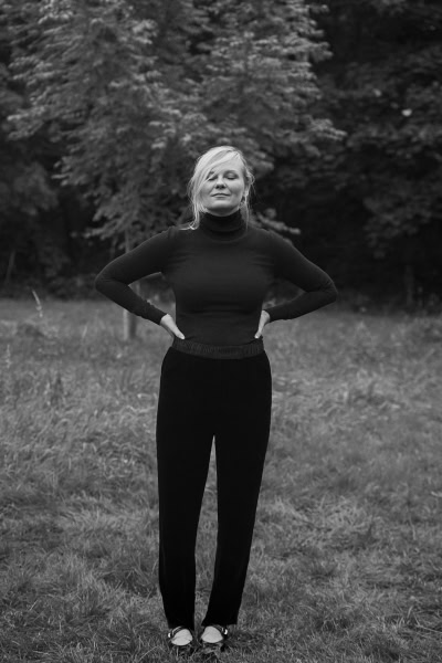 Elegant black and white portrait of a woman outdoors, showcasing timeless fashion photography by Pamela Hanson.
