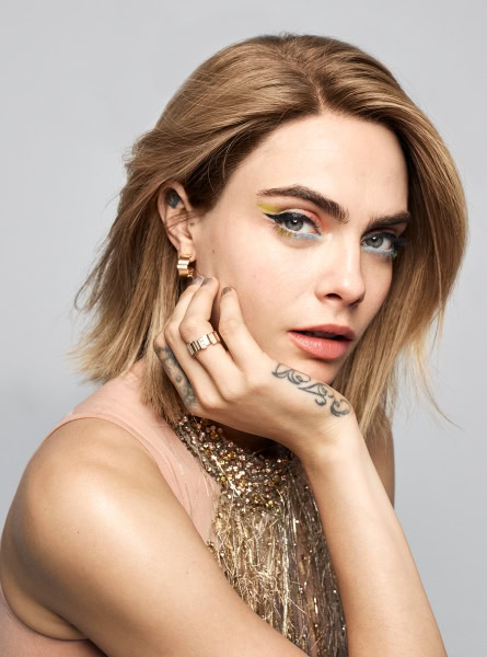 Fashion portrait of a woman with colorful eye makeup, earrings, and jewelry, showcasing professional photography by Pamela Hanson Photography.