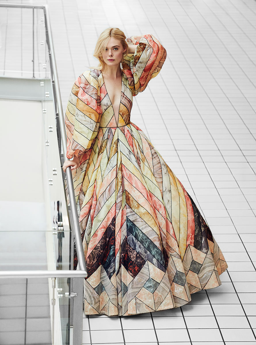 Luxury fashion model in colorful geometric patterned gown at modern building, Pamela Hanson Photography, high fashion editorial, stylish urban portrait, contemporary style, artistic clothing photography.