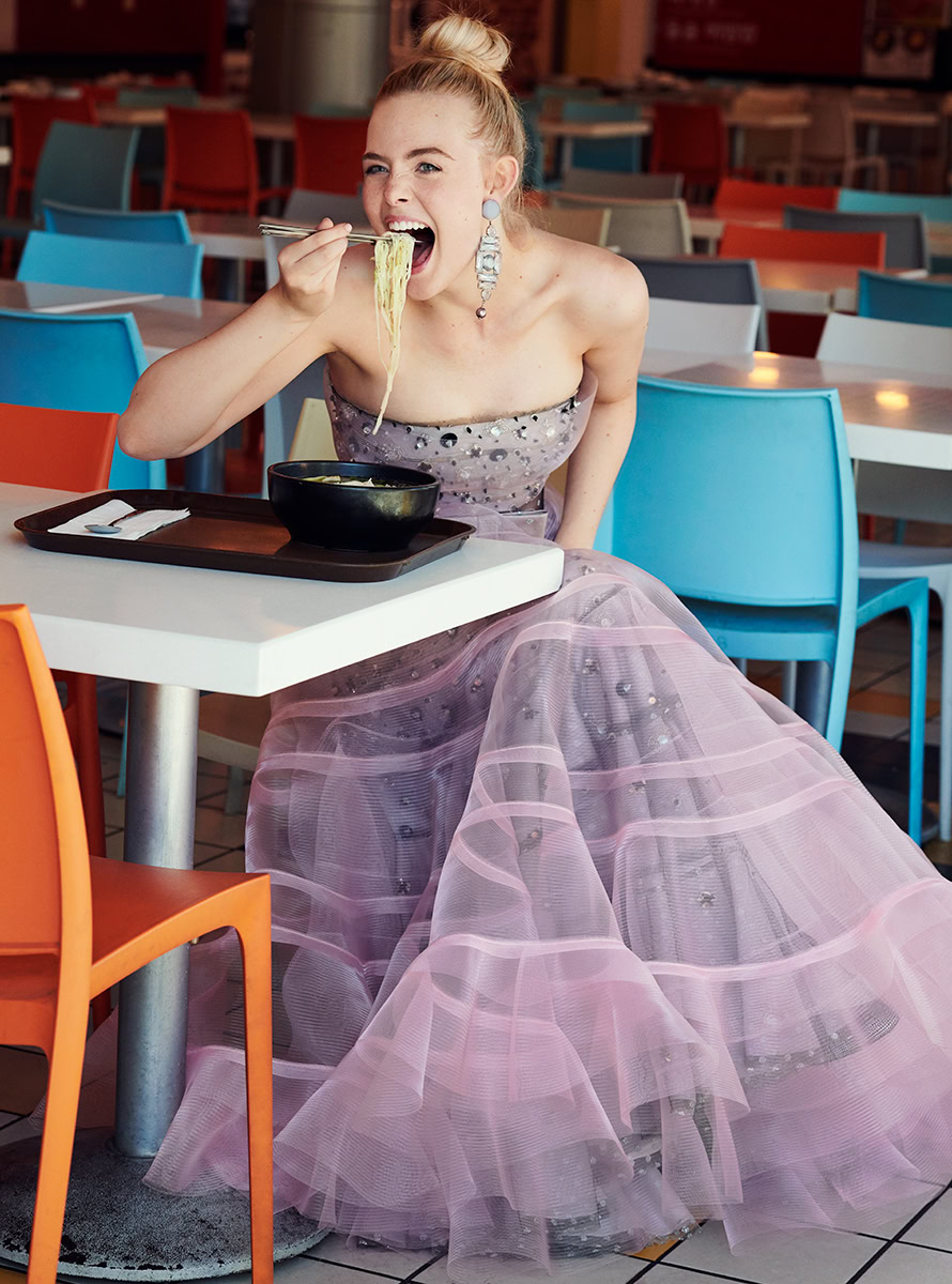 Elegant woman enjoying ramen at a colorful restaurant in a glamorous dress.