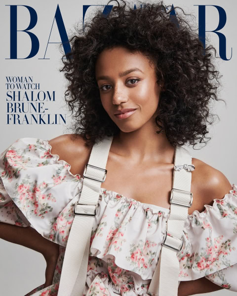 Elegant portrait of a woman with curly hair wearing a floral dress with suspenders, style photography, fashion imagery, Pamela Hanson Photography.