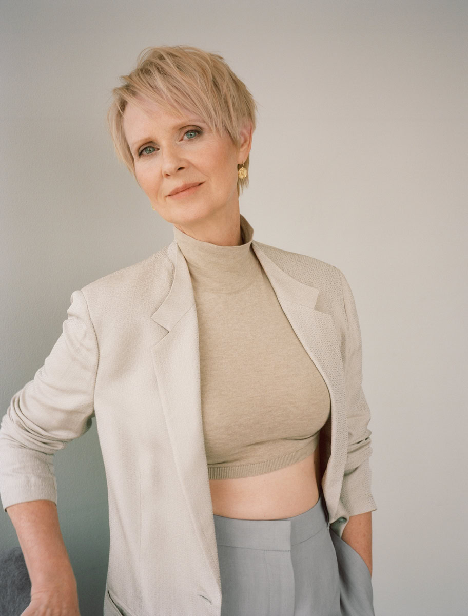 Elegant portrait of a mature woman with short blonde hair, wearing a beige blazer and crop top, captured by Pamela Hanson Photography for sophisticated fashion and portrait photography.