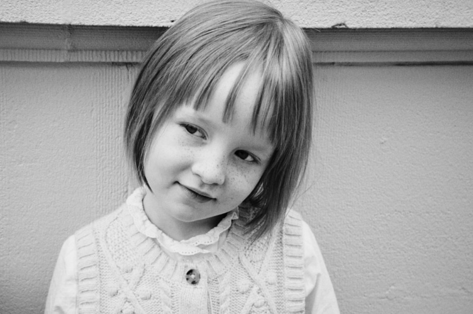 Portrait of a young girl with short hair and freckles, captured in black and white by Pamela Hanson Photography.