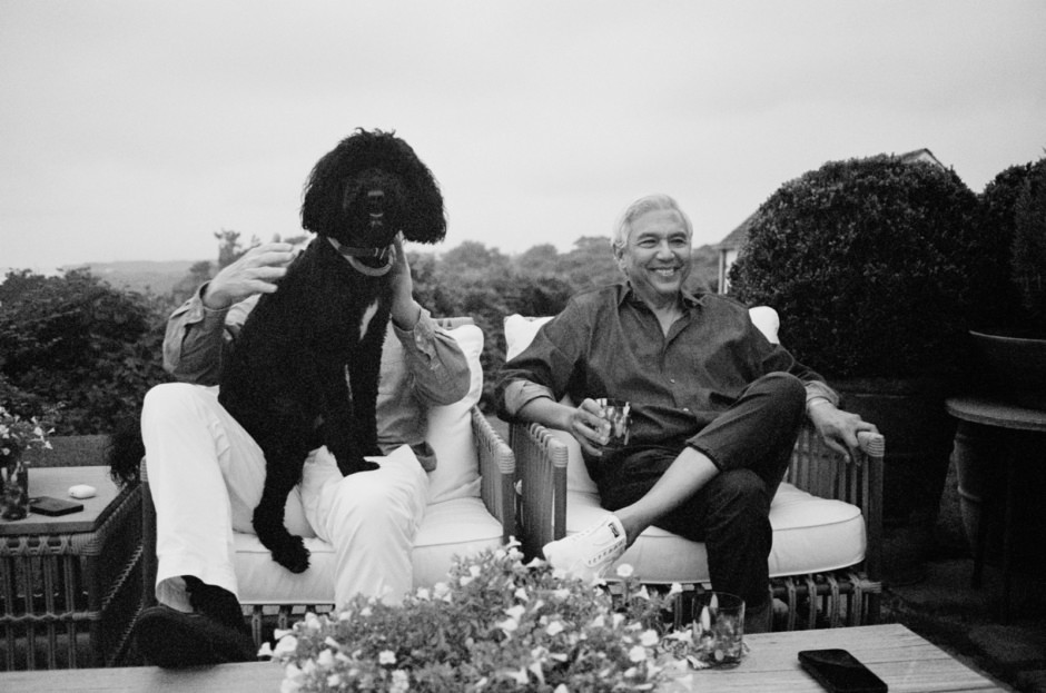 Elegant black and white portrait capturing joyful friends relaxing outdoors, featuring a stylish dog and candid moments, showcasing Pamela Hanson's fine art photography and portrait photography expertise.
