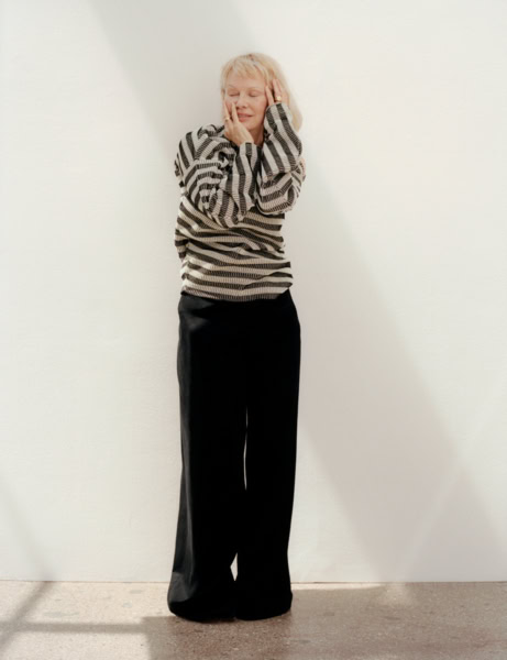 Elegant woman portrait showcasing fashion photography by Pamela Hanson, featuring stylish black wide-leg trousers and a patterned sweater, perfect for editorial and professional portfolio images.