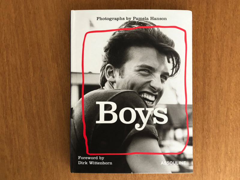 Young man smiling in black and white photo on the cover of the book "Boys" by Pamela Hanson, highlighting portrait photography and male subjects.