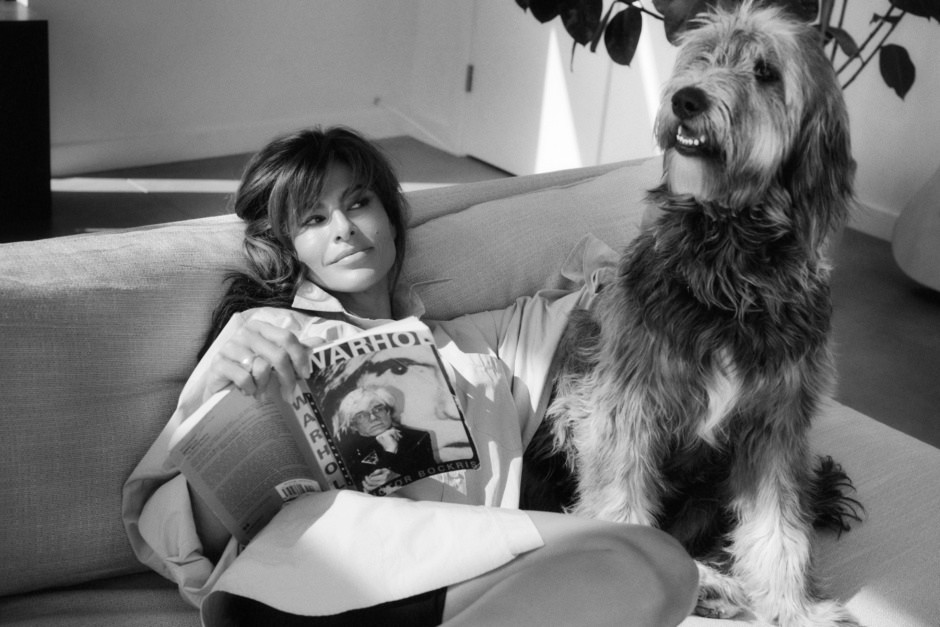 Woman relaxing on sofa with dog, reading magazine, modern interior, black and white photography, lifestyle portrait - Pamela Hanson Photography.