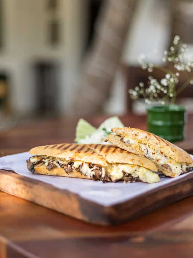 Philly cheesesteak sandwich toasted on a plate