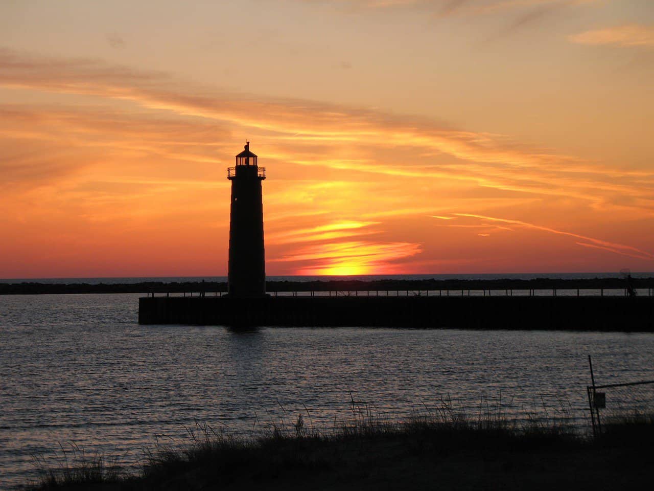 Beach and lighthouse at sunset