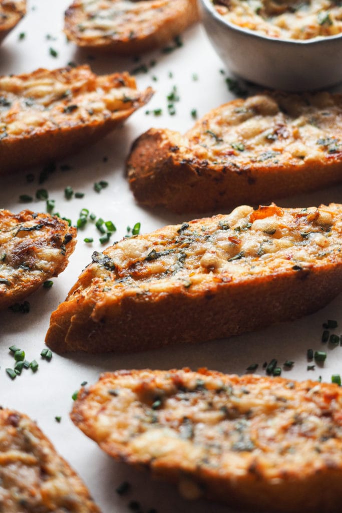 Pizza Style Garlic Confit Bread is a real crowd-pleaser. Good butter is mixed with fresh herbs, sundried tomato, cheese, and garlic. But not your average roasted garlic, confited garlic instead. It provides a gentle garlic flavour, so don't be afraid about your breath afterwards! It's perfect as an appetiser or side to accompany your soups and salads, your choice, but in any case, it will knock your socks off. | Paula's Apron Recipe