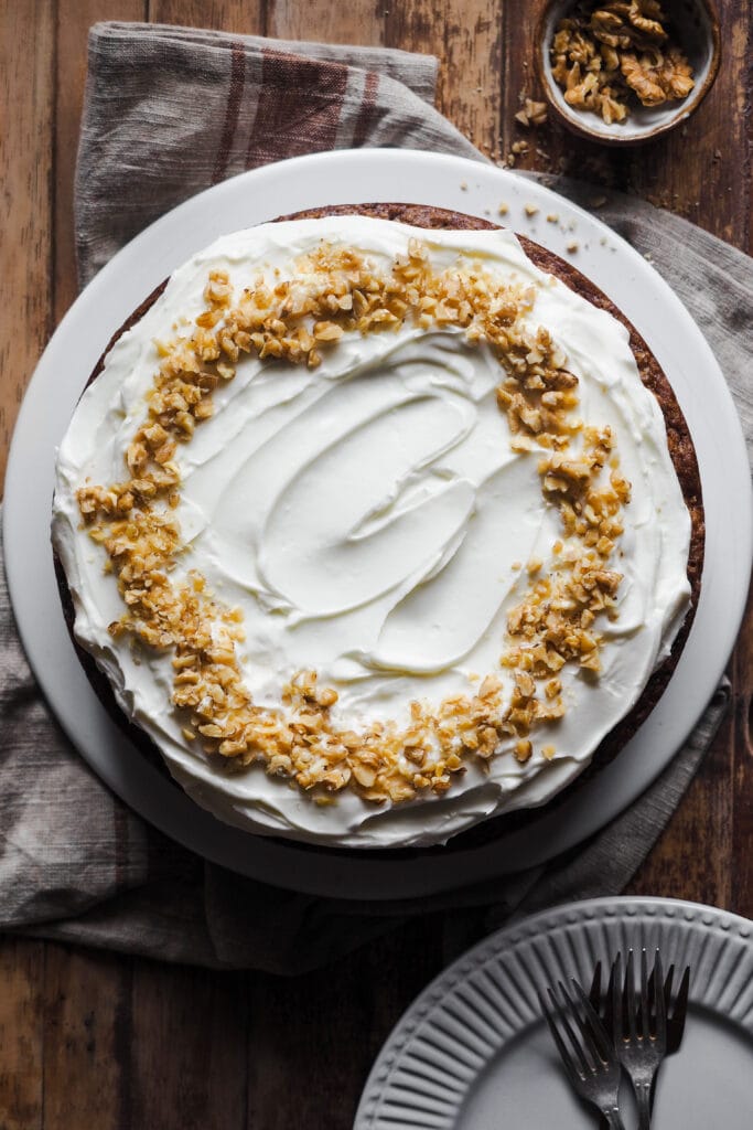 Este es el Mejor Carrot Cake para cualquier ocasión (o la Mejor Tarta de Zanahoria, lo llames como lo llames). Húmedo, sabroso y fácil de hacer, verás que no habrá quien no te pida un segundo trozo. Y es que gusta tanto a quien prefiere un carrot cake húmedo como al que no tan húmedo, al que lo quiere esponjoso y al que le gusta más denso, así que... Ya sea para una tarta de cumpleaños, un día festivo o simplemente porque sí, esta versión de tarta de zanahoria siempre triunfa. Yo hago tarta de zanahoria con nueces, pero puedes omitirlas si quieres. Su versatilidad y balance realmente la ha convertido en la mejor tarta de zanahoria para cualquier ocasión con cobertura de queso crema. | Receta de Paula's Apron