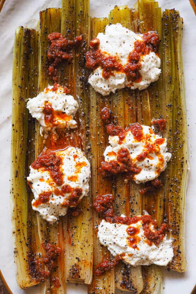 Puerros al Horno con Sobrasada y Burrata, un entrante, guarnición o platillo increíblemente fácil, pero muy resultón con tan solo 3 ingredientes principales. Los puerros son otra de esas verduras que solemos dejar en segundo plano en sopas, cremas, sofritos... Pero puede ser un protagonista increíble y para demostrártelo quería compartirte esta receta de puerros asados al horno. | Receta de Paula's Apron