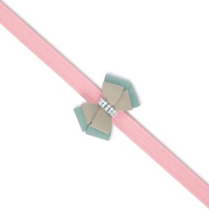 Pink dog leash with a decorative bow featuring a rhinestone band, designed for stylish pet accessories from Paws With Fashion.