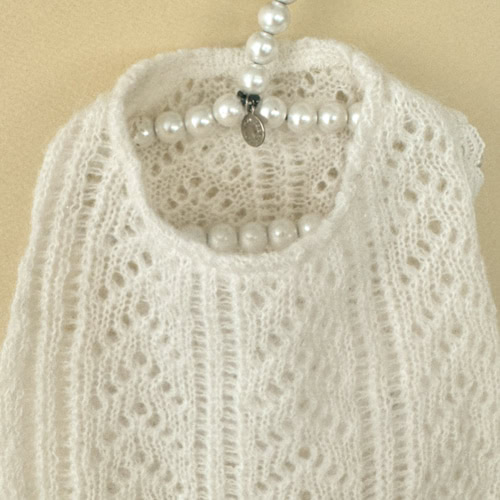 Delicate white knitted dog sweater with intricate patterns, suitable for fashionable pets and everyday comfort. Perfect for dog owners seeking stylish, cozy winter attire for their pets.