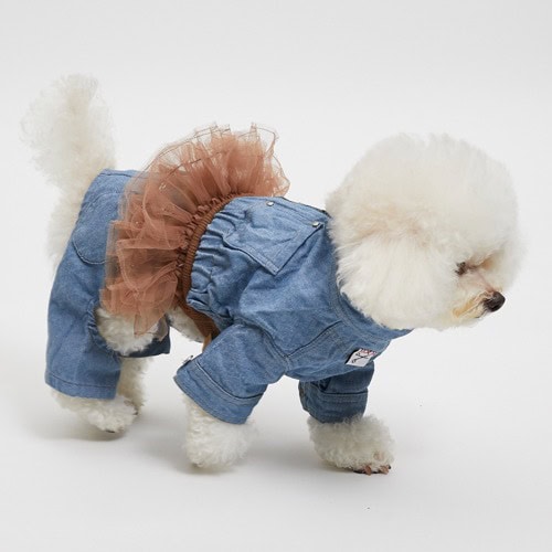 Fluffy white Bichon Frise in fashionable denim dog jumpsuit with tutu skirt, stylish pet clothing from Paws With Fashion, perfect for small dogs, fashionable dog apparel, trendy pet costumes.