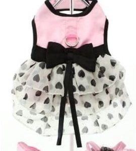 Pink and black polka dot dog dress with bow and ruffle details, perfect for fashionable pets.