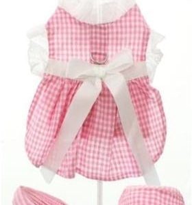 Pink gingham dog dress with ruffle collar and bow for fashionable pet outfits.