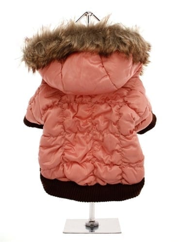 Cozy pink dog winter coat with faux fur-lined hood, waterproof outer layer, and adjustable fit, perfect for cold weather and fashionable pet winter apparel.