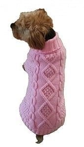 Cute small dog wearing a pink cable-knit sweater, perfect for winter comfort and style.