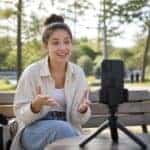 Content creator filming a video outdoors on a smartphone