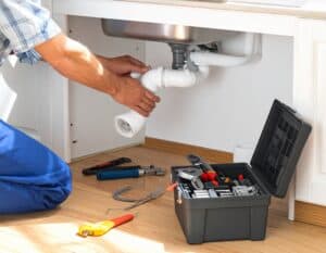 Plumber-Installing-Sink-Drain-Pipe