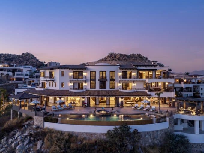 Stunning Multi-Level Cliffside Estate With Infinity Pool And Expansive Terrace At Dusk In Pedregal Real Estate, Cabo San Lucas.